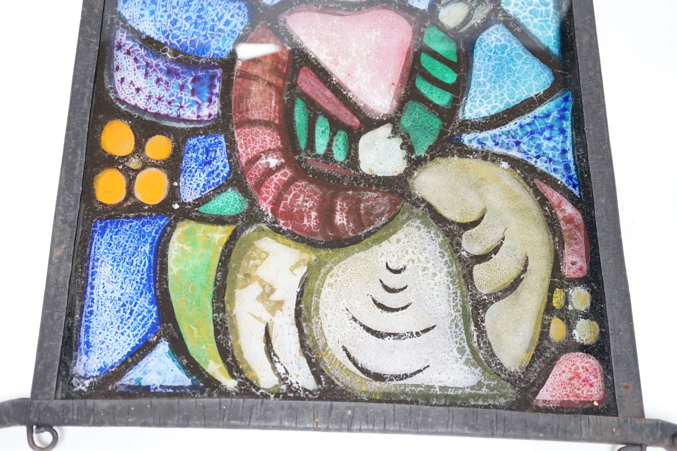 A rectangular wrought iron framed stained glass panel, 44x36cm total